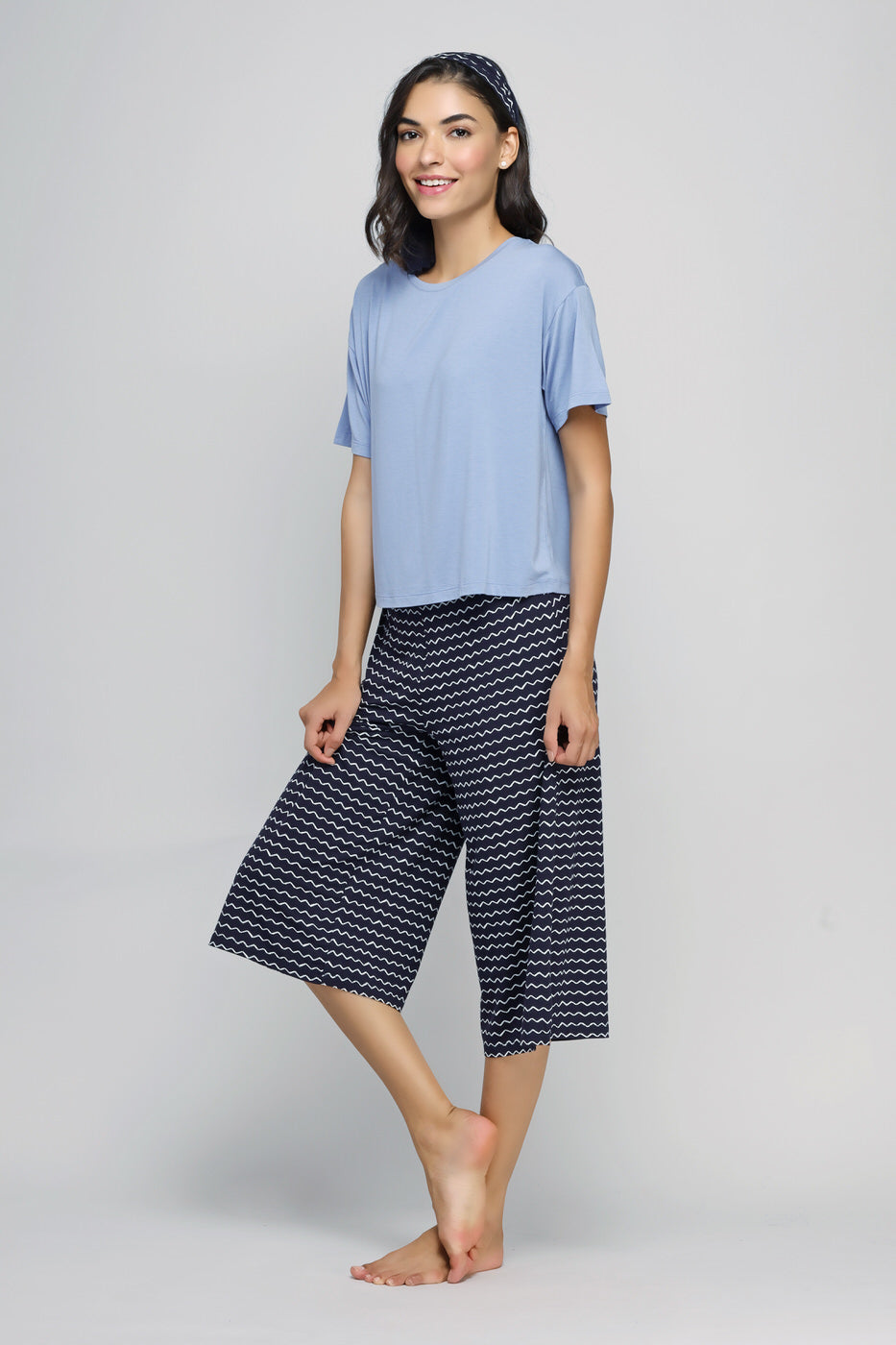 Stylish woman wearing Dancing Frenzy Culotte Set in blue and patterned culottes.