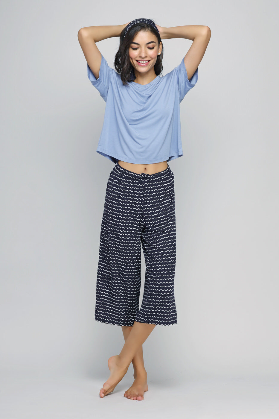 Fashionable model in Dancing Frenzy Culotte Set, stylish blue top and printed pants.