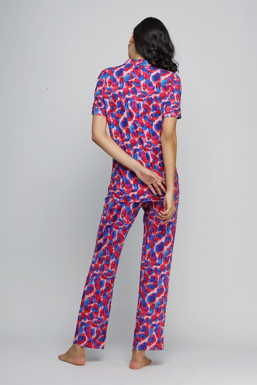 Artsy watercolor button-down pajama set in vibrant colors, model showcased.