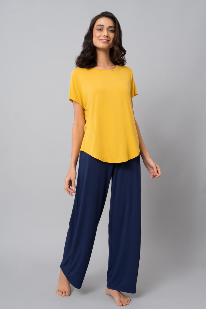 Buttercup yellow top paired with navy blue pants, perfect for casual wear.