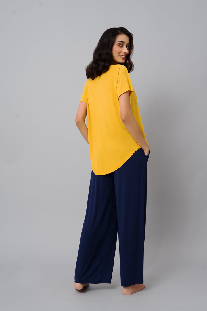 Model wearing Indigo Flared Lounge Set with yellow top and navy pants.