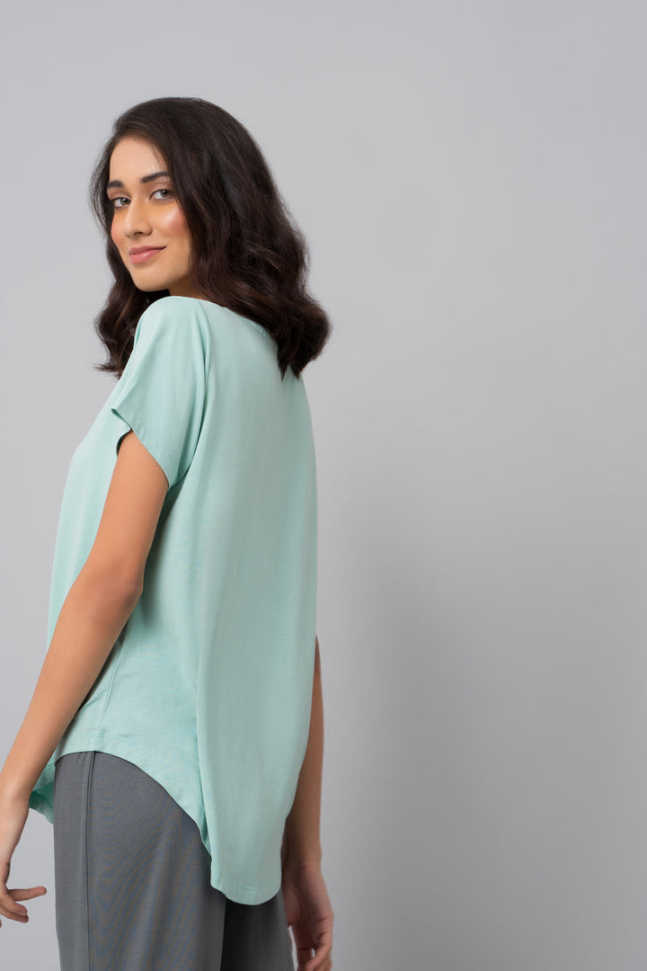 Delicate teal top designed for a relaxed, casual look.