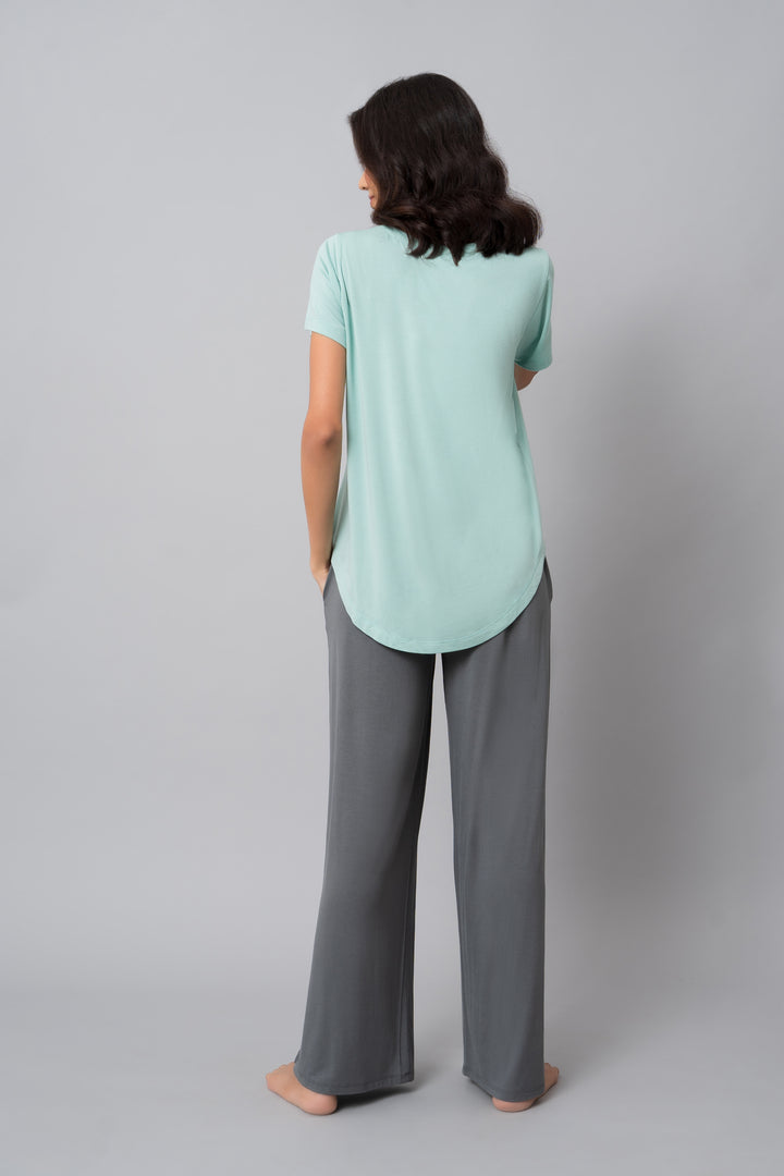 Woman wearing a comfortable grey pearl flared lounge set from the back.