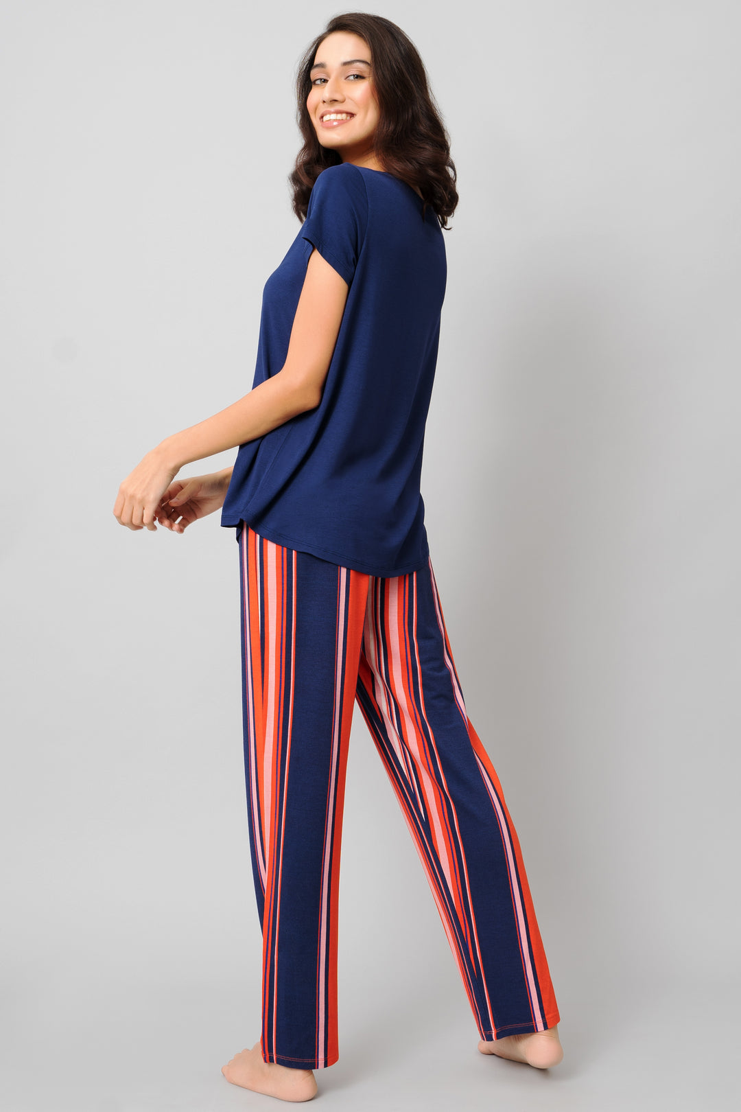 Classic Stripe Pajama Set featuring vibrant striped pants and a navy top.