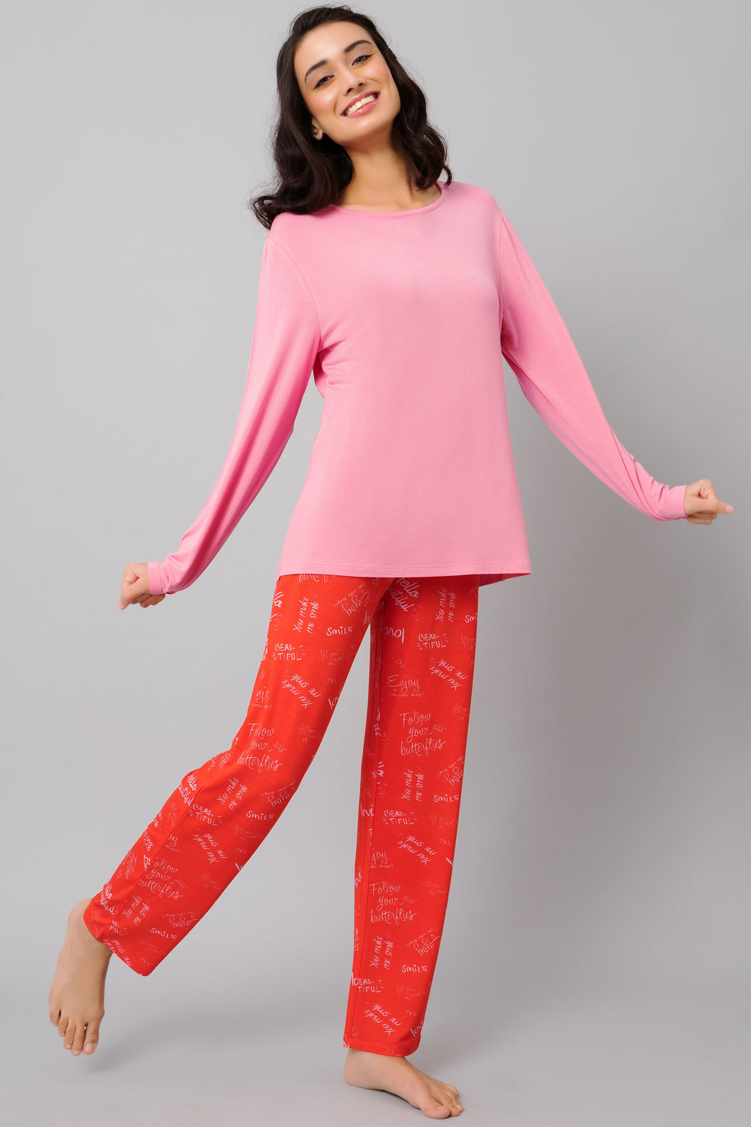 Cheerful woman wearing Love Escape Pajama Set in pink and red.