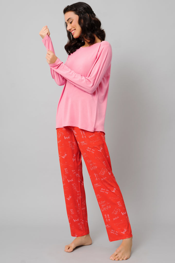 Love Escape Pajama Set featuring pink top and red patterned pants.