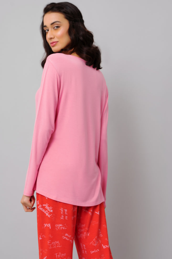 Model showcasing Love Escape Pajama Set in pink and red colors.