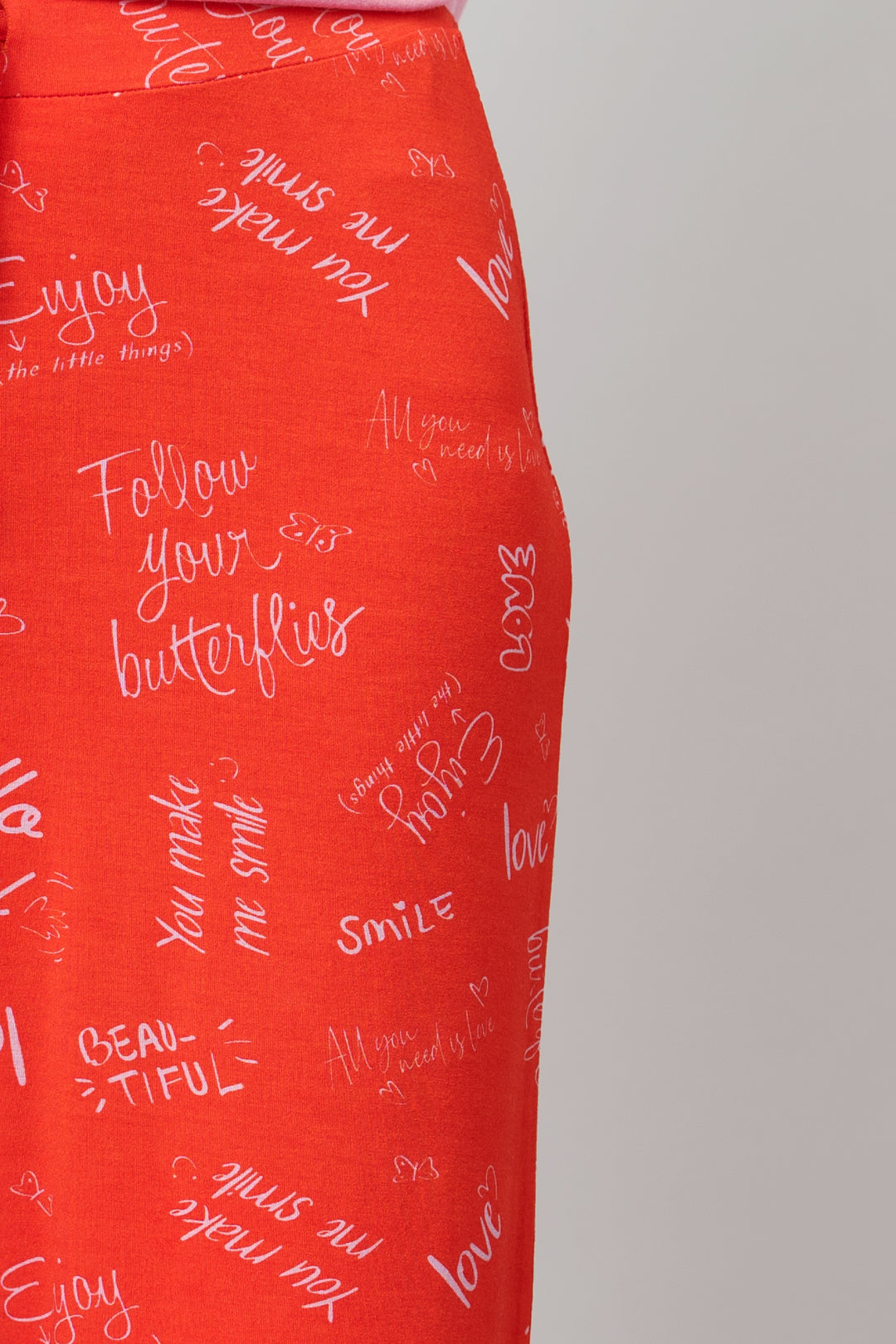 "Bright red shorts set with uplifting quotes and playful designs."