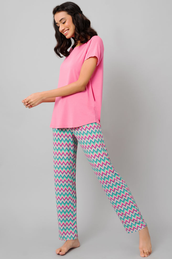 Mellow Pink Top paired with colorful zigzag patterned pants.