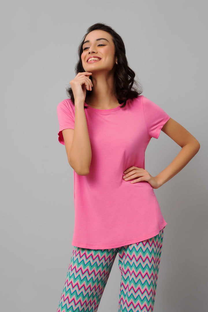 Mellow Pink Top styled with colorful patterned leggings.