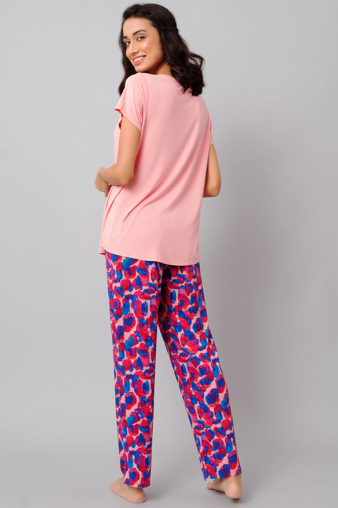 Artsy watercolor pajama set featuring a pink top and colorful pants.