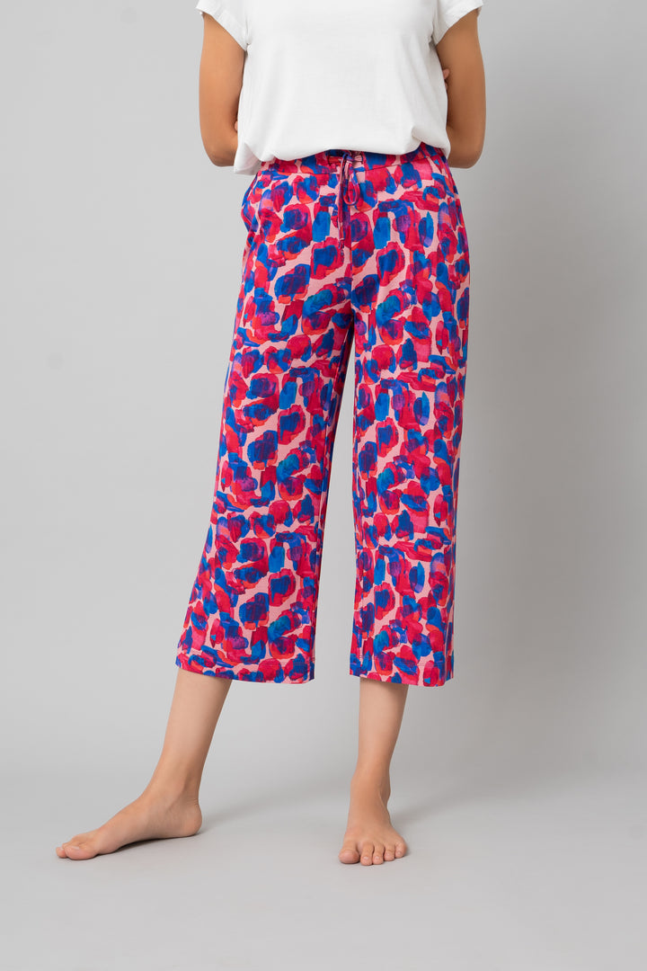 Artsy Watercolor Capri pants in vibrant pink and blue patterns.