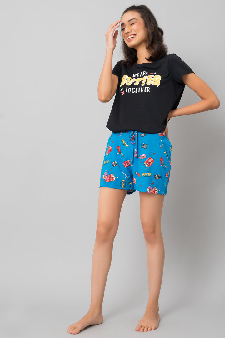 Model wearing Butter Together Shorts with fun, colorful food print.