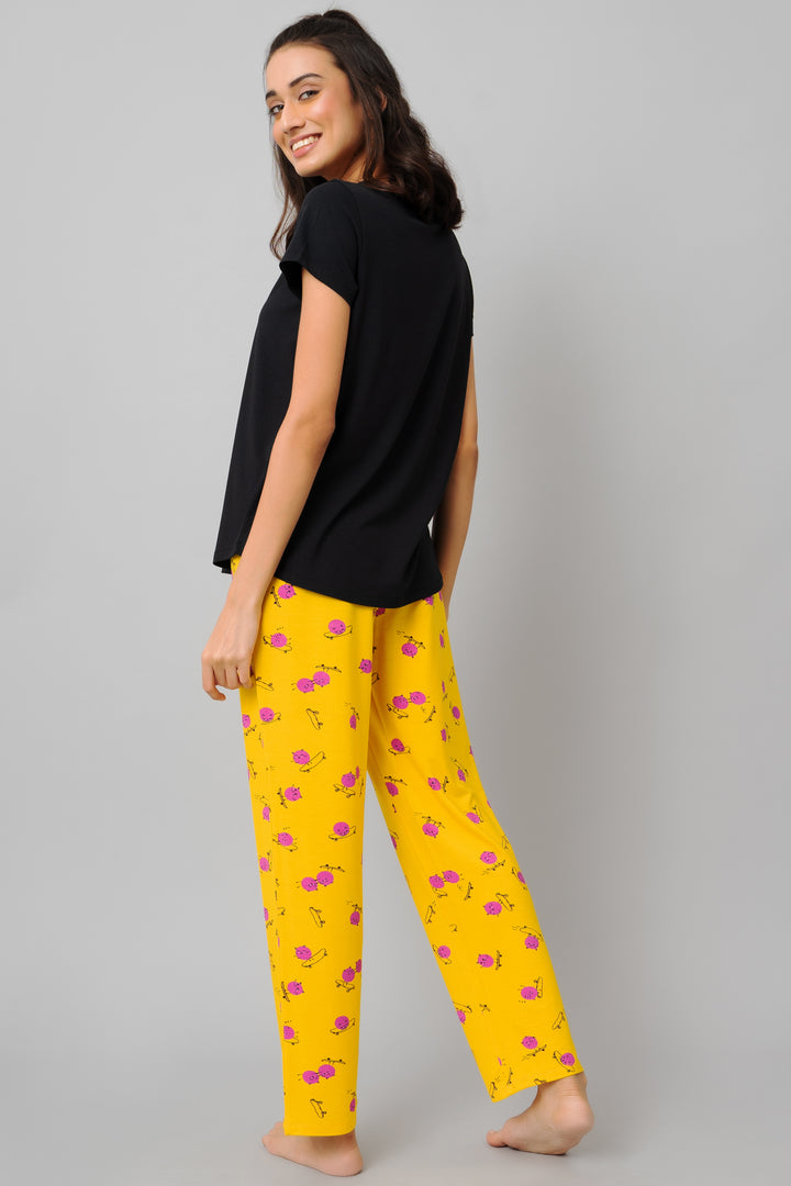 Fuffy Kitty Pajama Set featuring black top and yellow patterned pants.