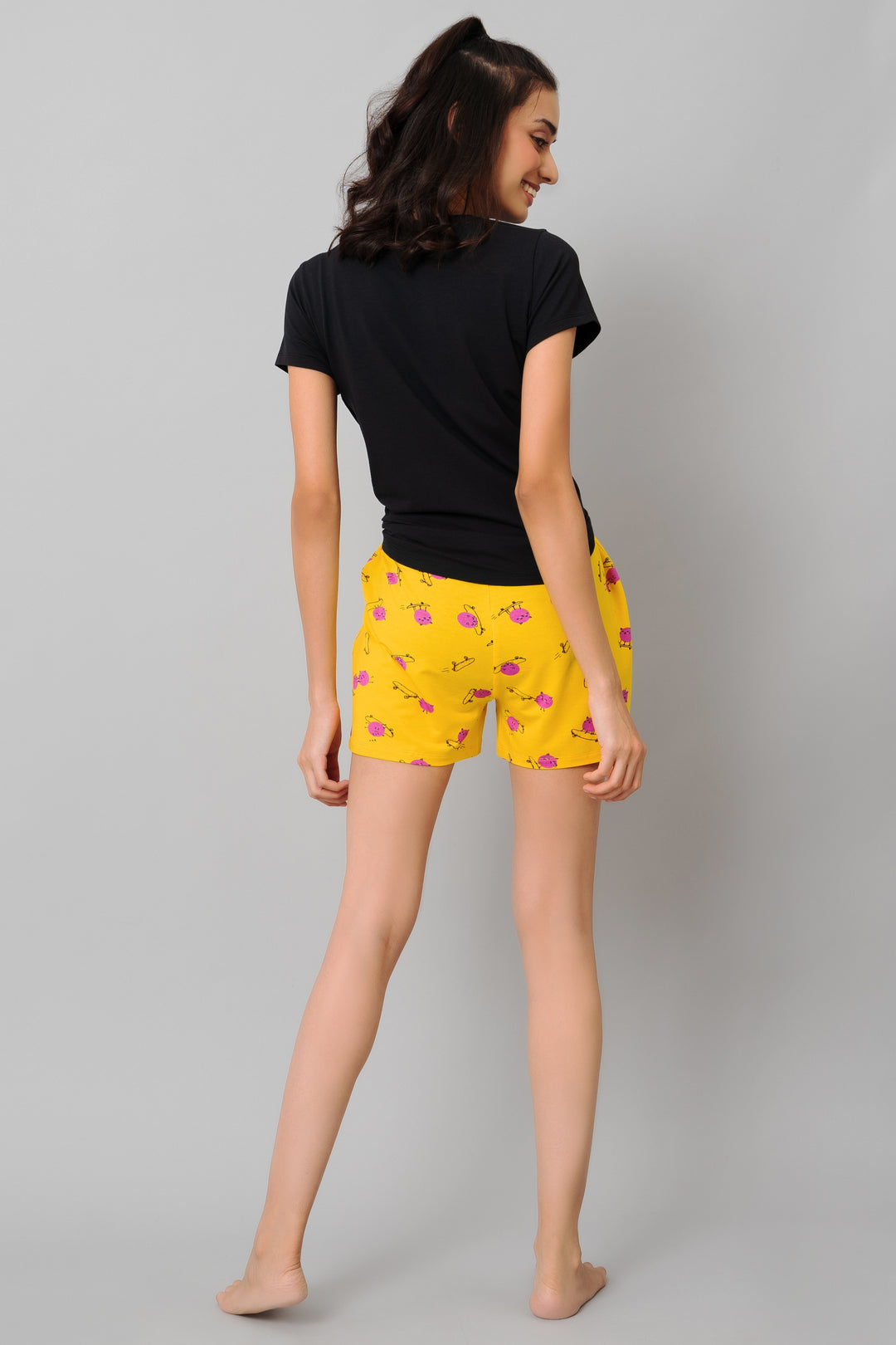 Model in "Oh Happy Day Shorts Set," featuring yellow shorts and black top.