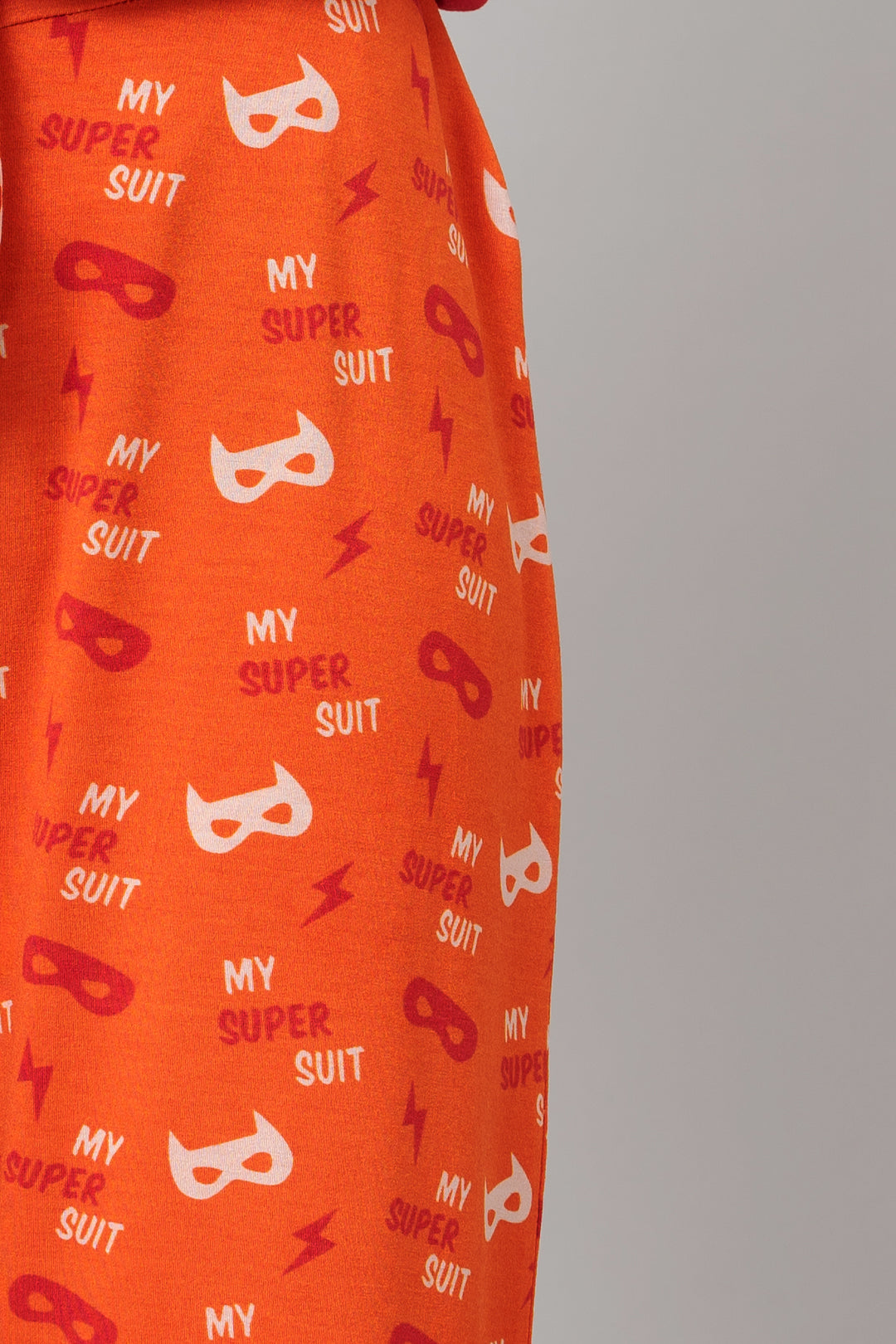 Frenzy Bolt Pajama Set featuring orange fabric with playful superhero designs.