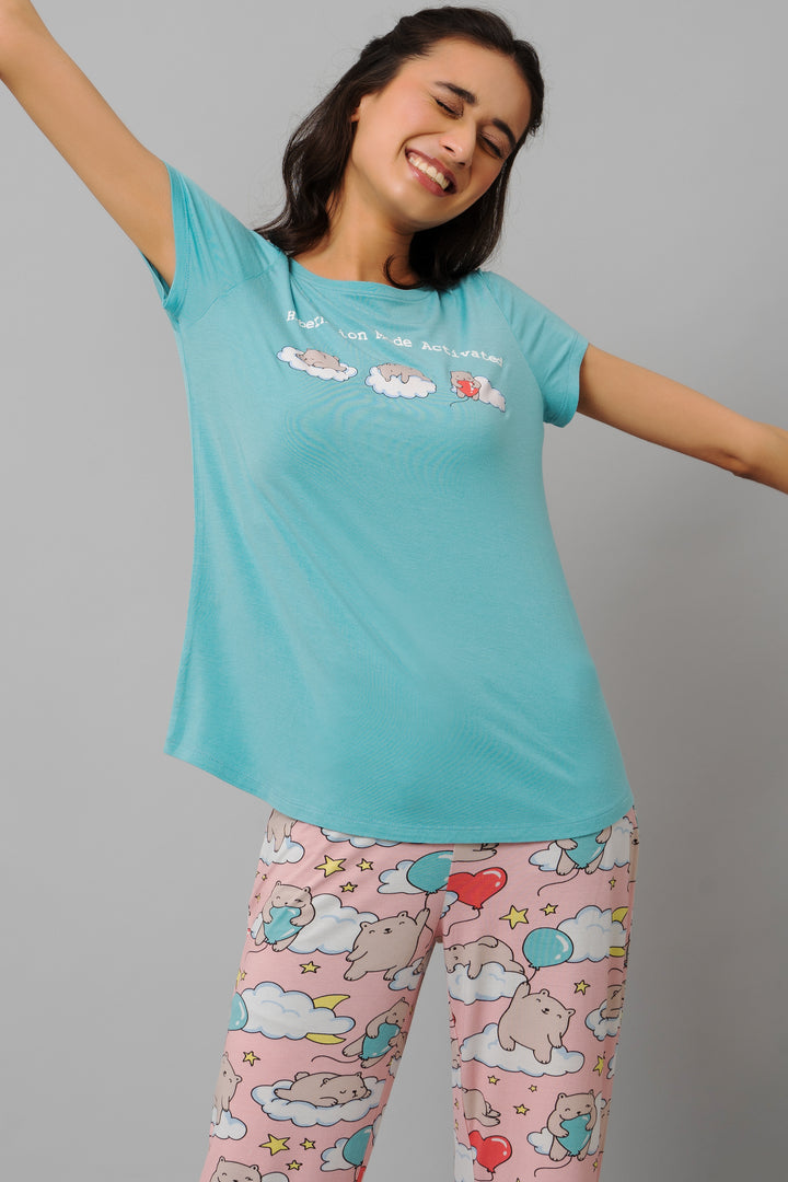 Cheerful woman wearing Hibernation Mode Capri Set, featuring cute cartoon designs.