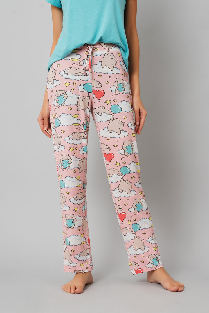 Cute pajama set with playful bear and balloon design.