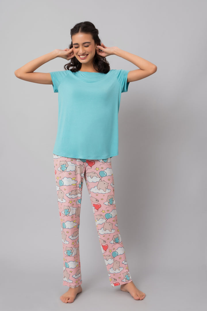 Teal top paired with cute patterned pajamas for cozy comfort.