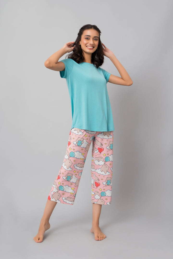 Woman wearing Dreamy Day Capri Set with playful cloud patterns.