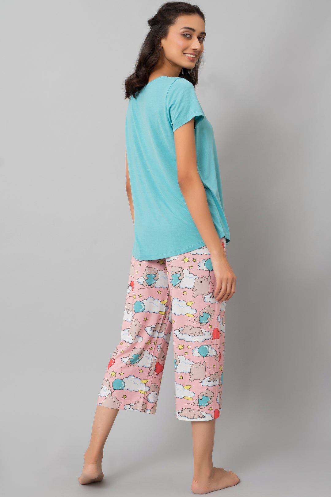 Stylish woman in Dreamy Day Capri loungewear set with playful patterns.