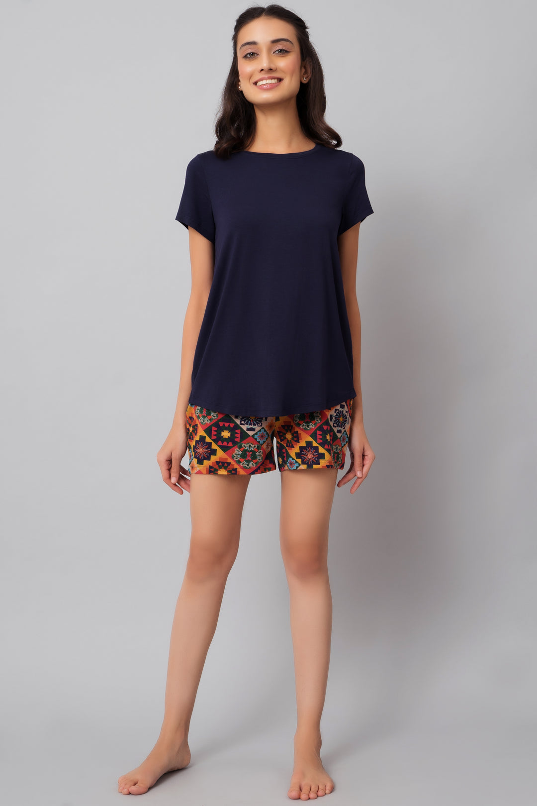 Floral Aztec shorts paired with a navy top, casual feminine fashion.