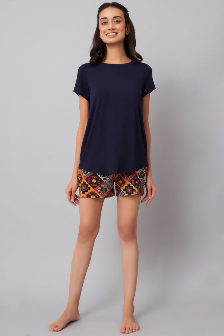 Floral Aztec shorts paired with a navy top, casual feminine fashion.