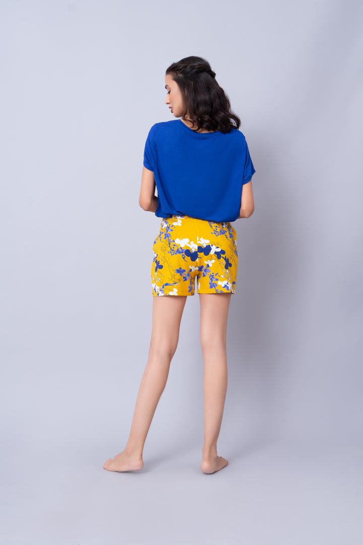 Floral Love Shorts showcased with a blue top, stylish summer outfit.