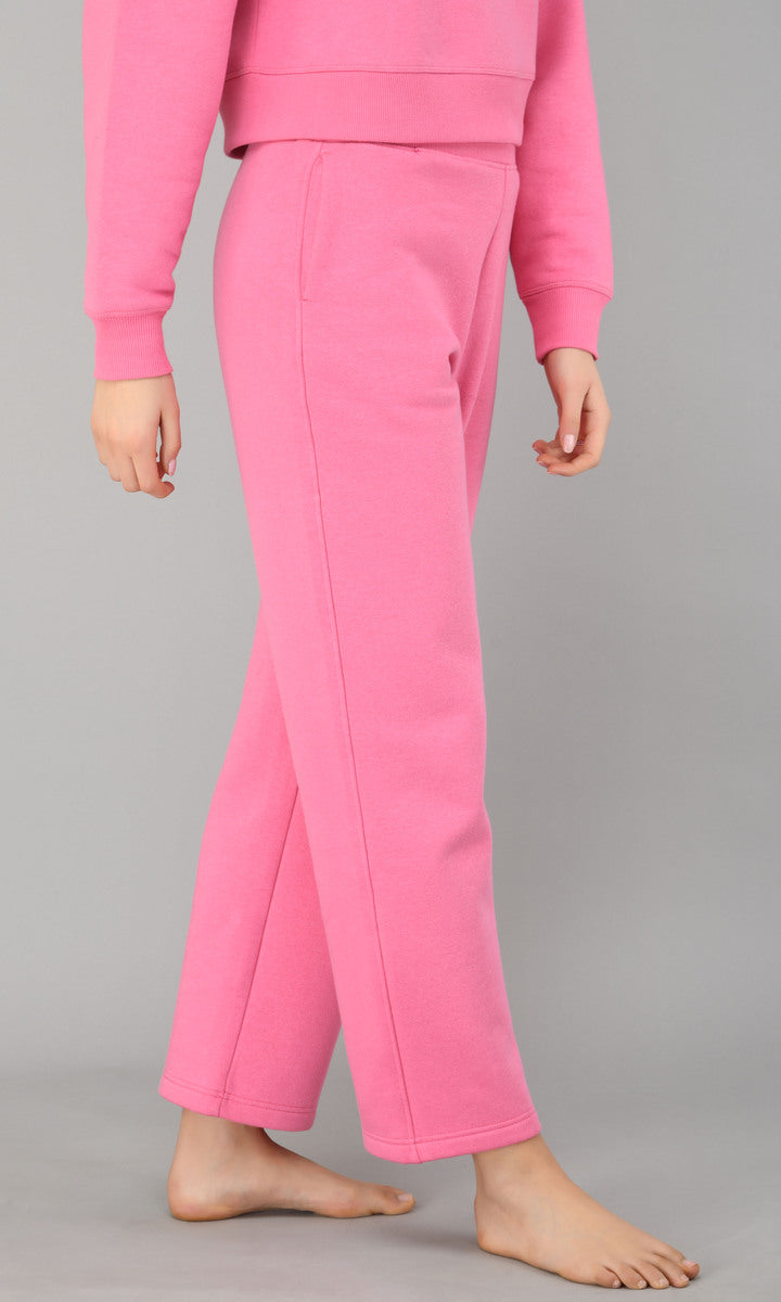 Pink fleece lounge set featuring cozy sweatshirt and relaxed pants.