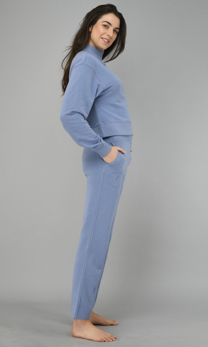 Ice-blue fleece lounge set modeled by a woman in relaxed pose.