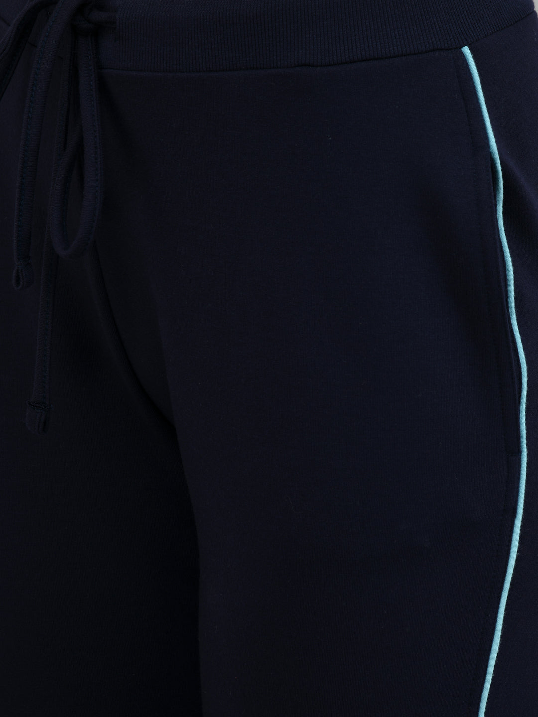 Navy jogger pants featuring stylish teal piping detail.