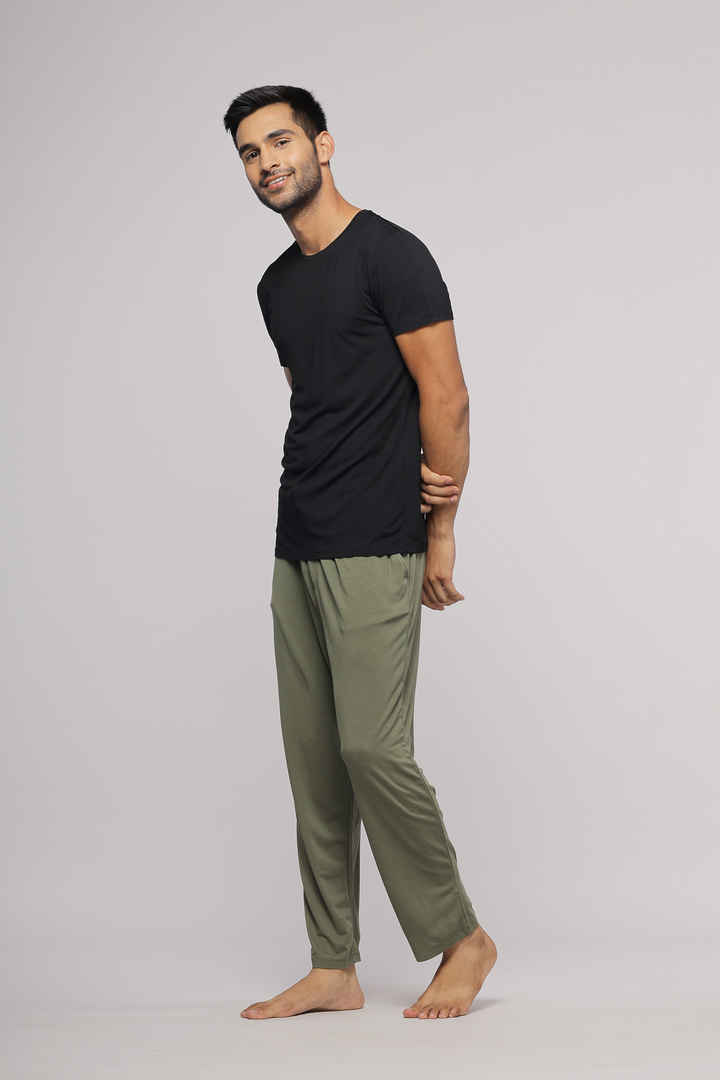 Everyday black men's t-shirt styled with casual green pants.