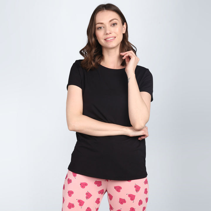 Black t-shirt and pink heart-patterned shorts for Nap Queen style.