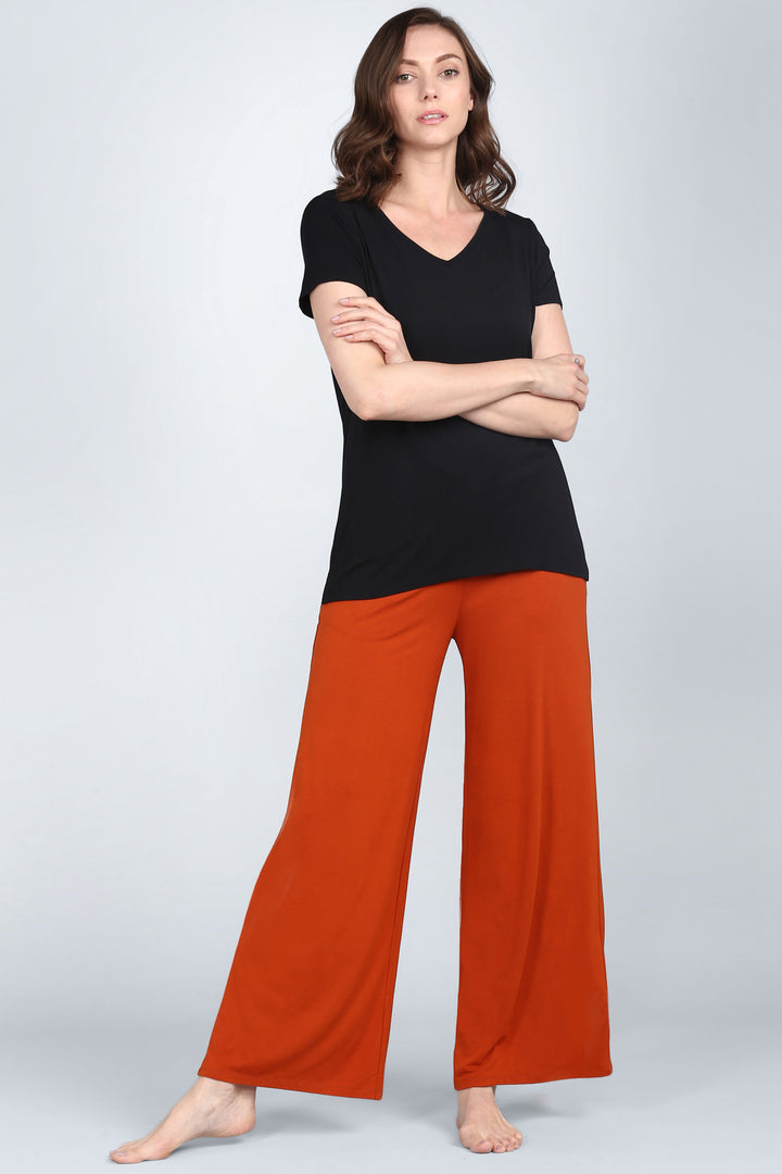 Effortless Black Lounge Set featuring a black top and orange pants.