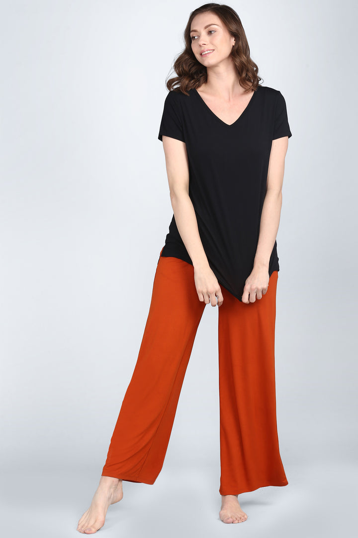 Woman wearing Potter Clay Lounge Pant with a black top.