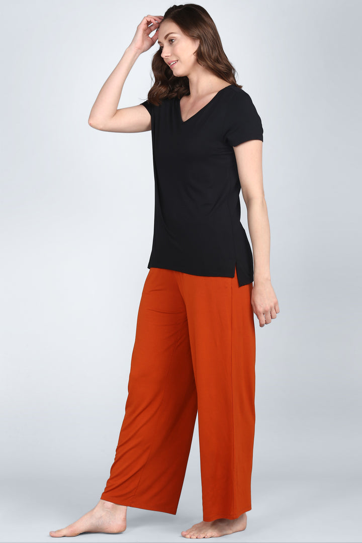 Effortless Black Lounge Set featuring a relaxed black top and orange bottoms.