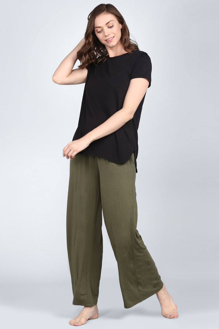 Elegant black lounge set styled with olive green pants.