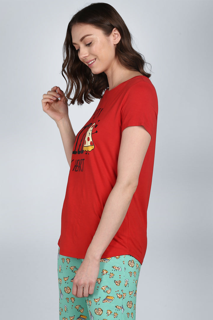 Model wearing "Pizza My Heart Capri Set" in vibrant red and patterned pants.