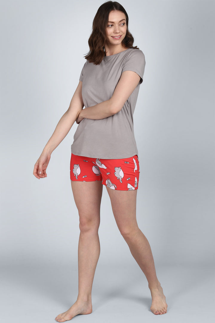 Woman modeling Lazy Cat Shorts with playful cat print.