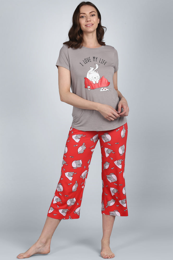 Woman wearing Lazy Cat Capri pajamas with playful cat design.