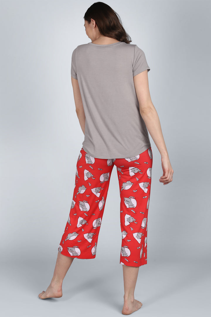 Woman wearing Lazy Cat Capri pants with playful cat designs.