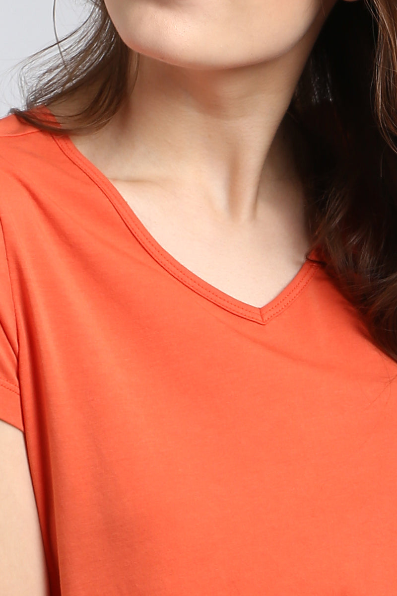 Melon Orange Top close-up, showcasing vibrant color and neckline design.