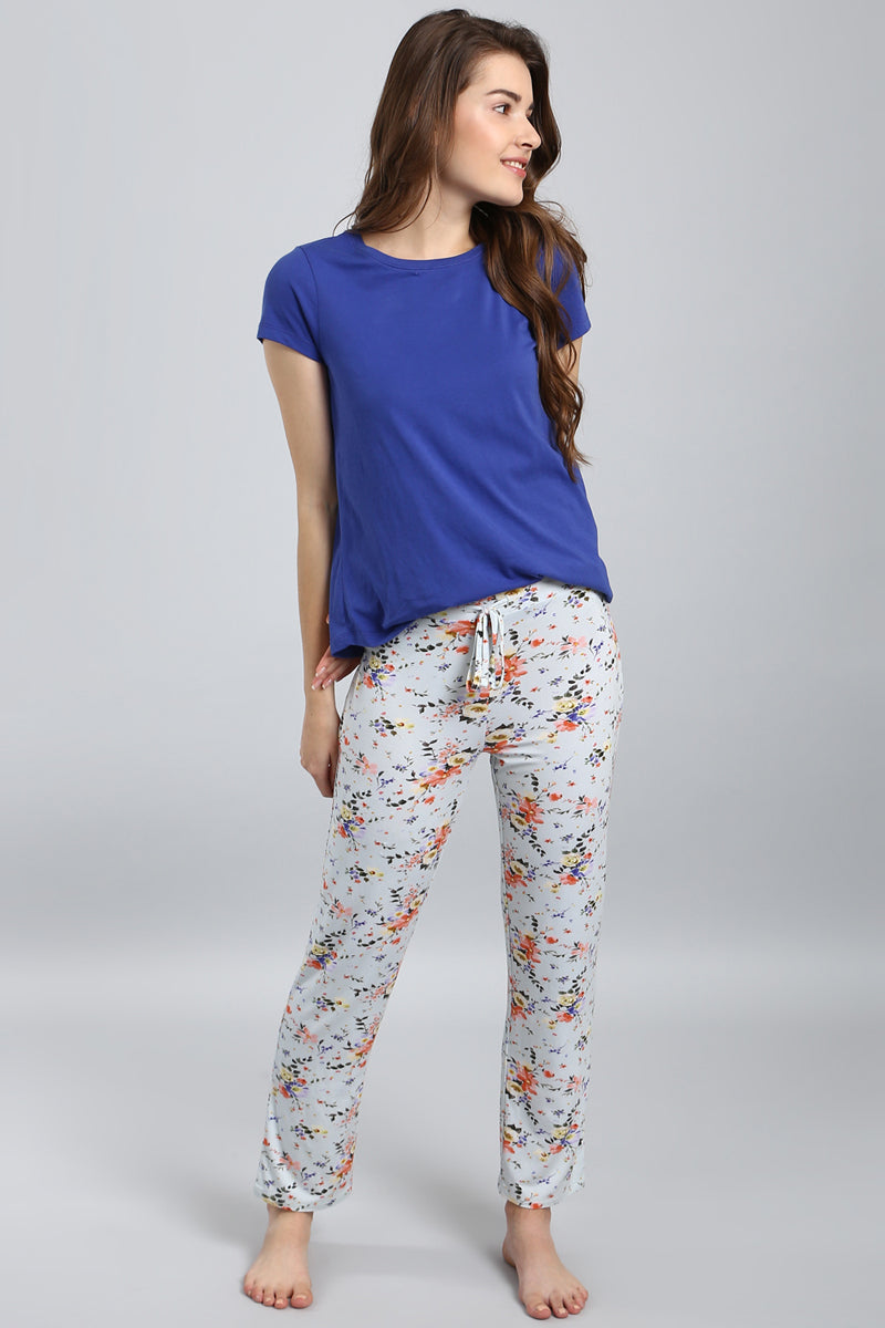 Delicate floral pajama set featuring a blue top and floral pants.