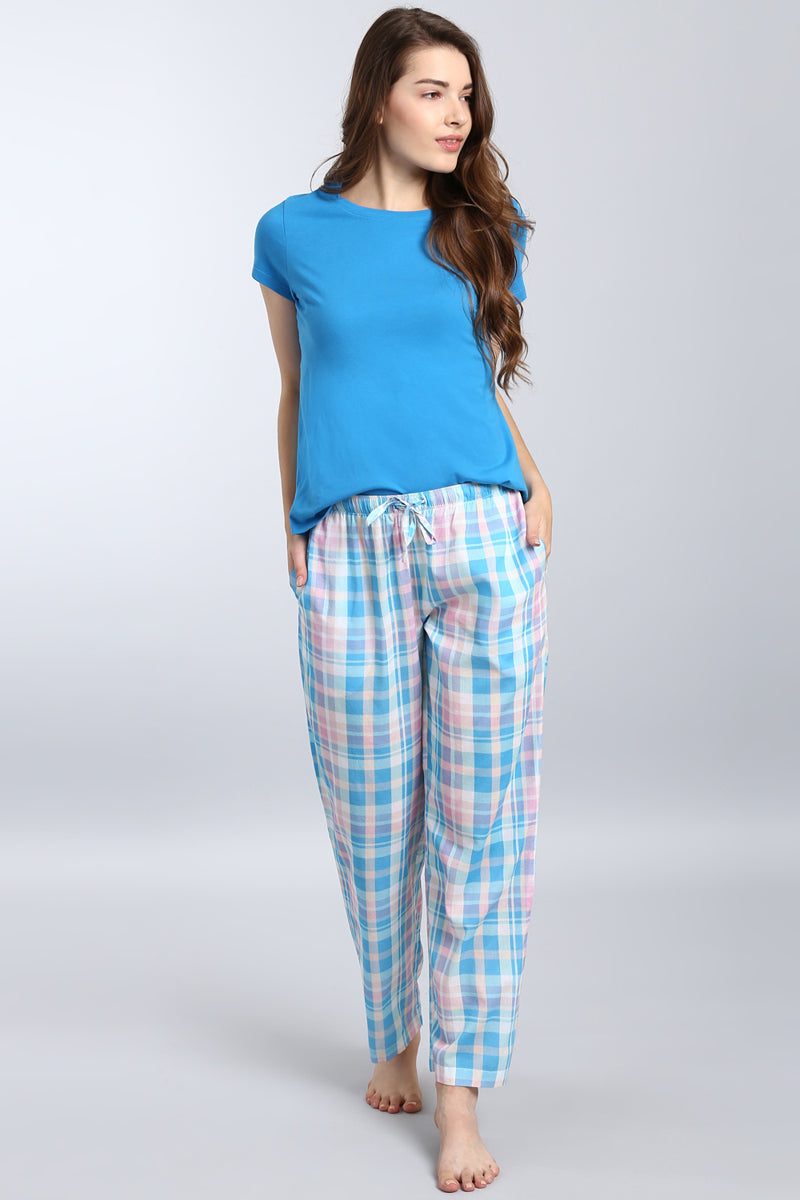 Soothing blue top paired with checkered pajama bottoms for comfort.