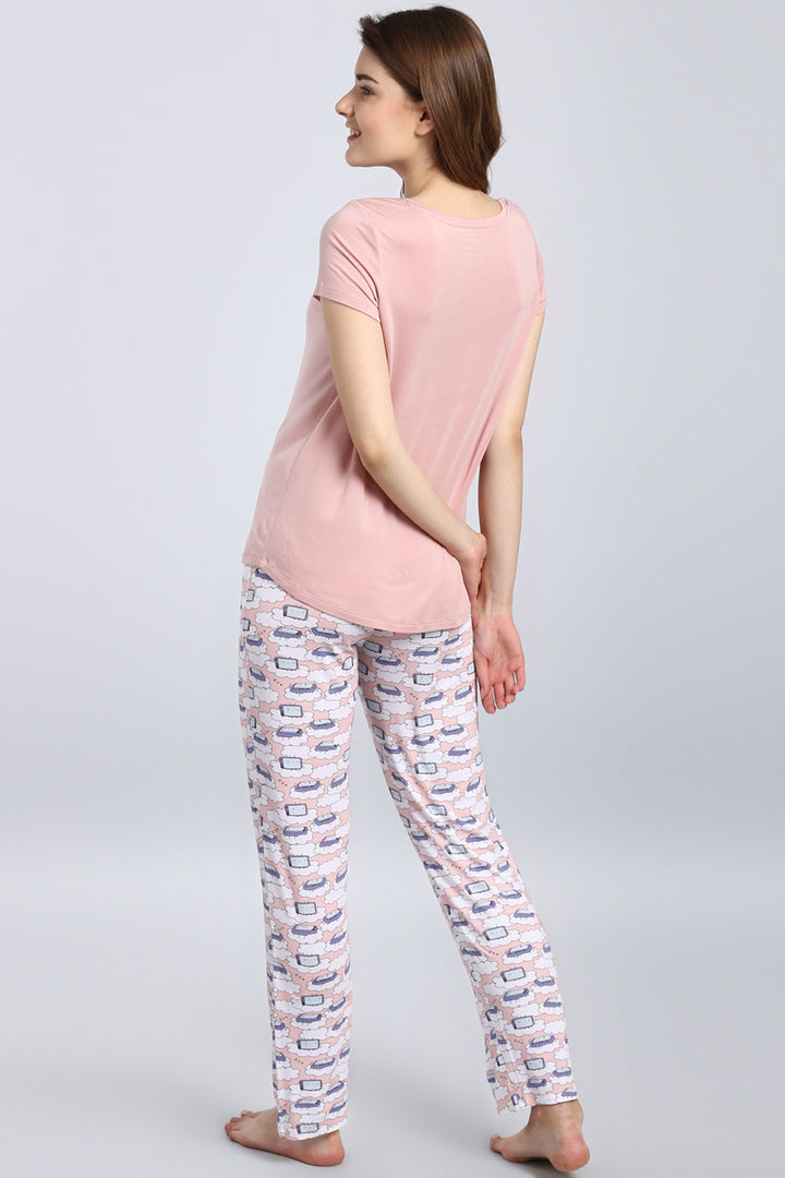 Woman wearing Sleepyhead Pajama Set with playful cloud design.