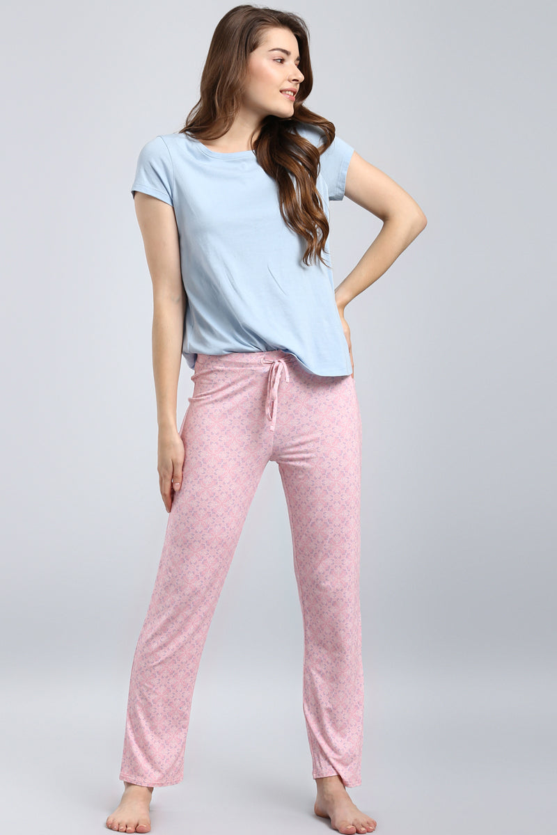 Model wearing a powder blue top with pink patterned pants.