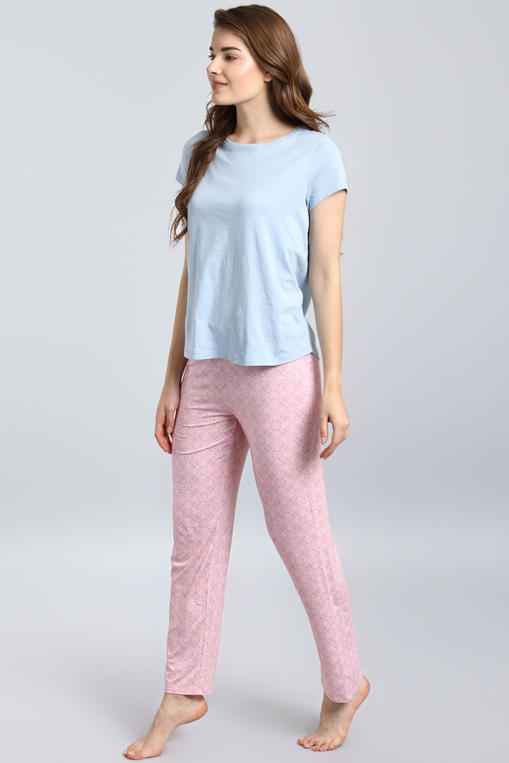 Woman wearing a stylish powder blue top with printed pants.