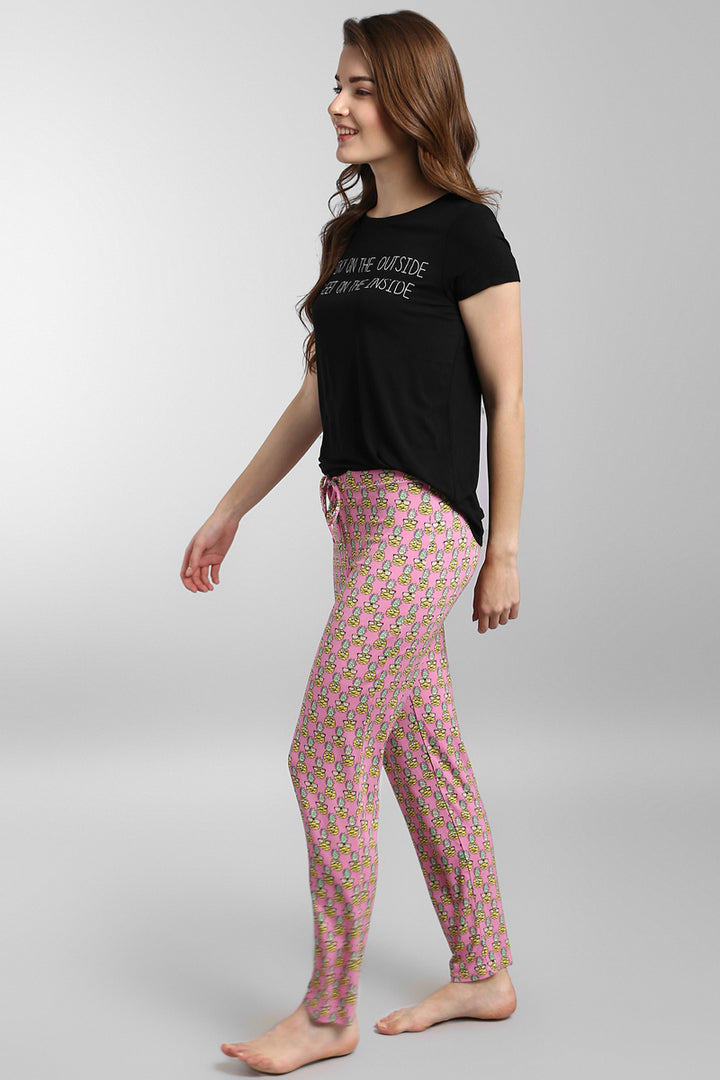 Tropical Vacay Pajama Set featuring black tee and pink patterned pants.