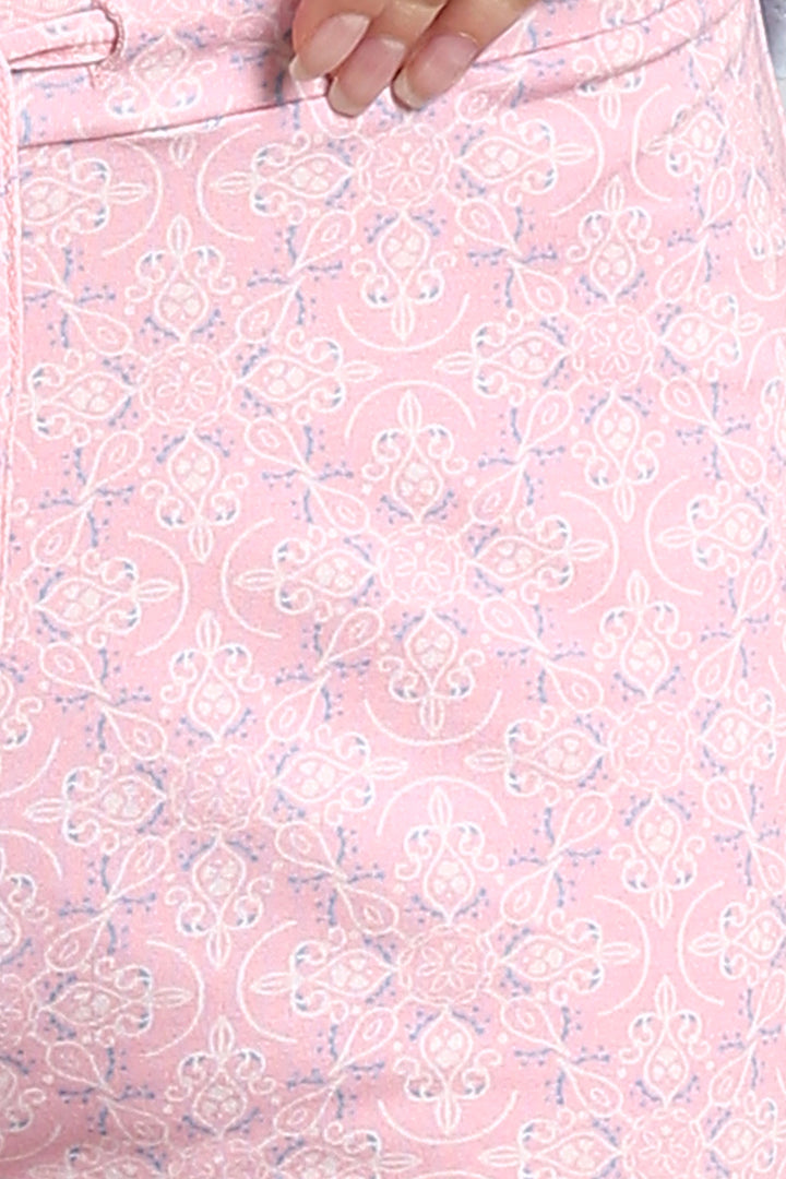 Blush pattern shorts with intricate floral design on soft pink fabric.