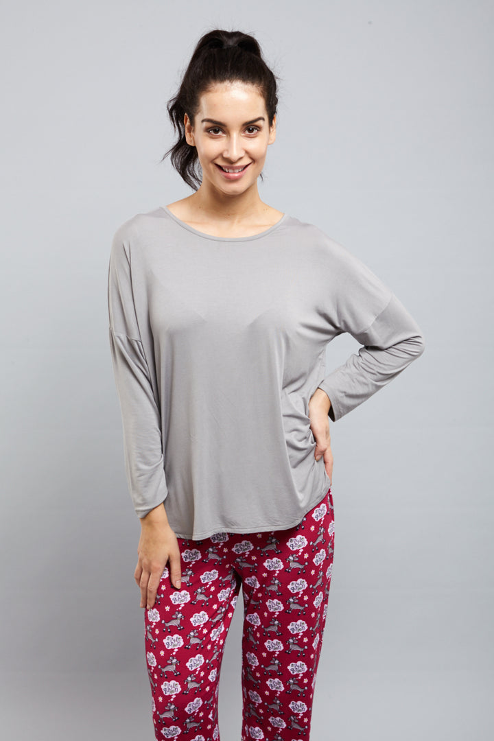 Model wearing Dreamy Grey Top with patterned pajama pants.